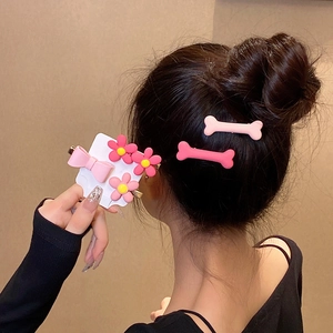 Pink heart flower and bow hair clips set shown on model and packaging card