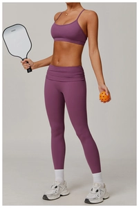 Detail of high-waist foldover yoga pants and U-neck sports bra set in deep purple fabric