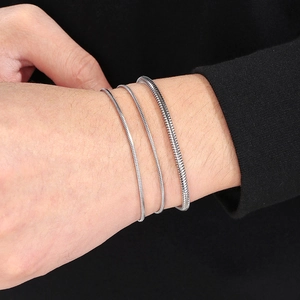 Three silver snake chain bracelets on wrist, adjustable minimalist titanium steel jewelry