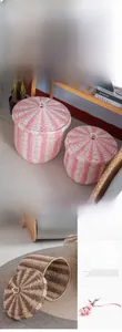 Detail of woven Nordic storage baskets with lids in pink and brown striped patterns