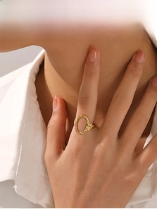 Detail of vintage gold open ring with hammered texture and oval hollow design on finger