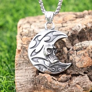 Gothic punk crescent moon and skull necklace with vintage silver finish on wood