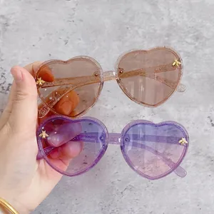 Sparkly glitter heart-shaped kids sunglasses with bee accents and gradient lenses