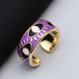 Macro detail of adjustable purple enamel evil eye ring with gold eyelashes decor