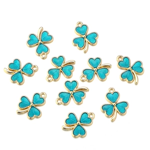 Detail of ten gold-edged green enamel clover charms with fine radial texture