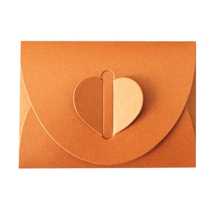 Orange metallic pearlescent kraft paper envelope with a heart-shaped folding closure