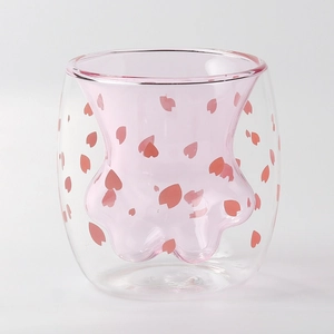 Double-walled glass cat paw mug with pink flower petals and insulated design