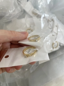 Detail of 18K gold plated chain ring with a small zircon stone, showing Size 7 label