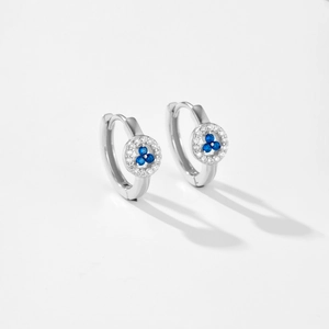 Detailed macro view of S925 silver hoop earrings with blue sapphire and zircon accents