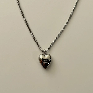 Polished silver heart pendant necklace with mon amour engraving on a box chain