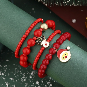 Detailed view of red beaded Christmas bracelets with Santa and reindeer charms set