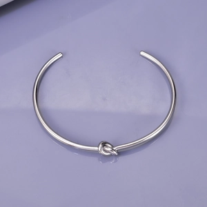 Polished silver knot open cuff bangle with a minimalist design for daily wear