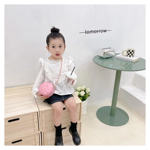 Pink quilted circular crossbody bag for little girls paired with white frill shirt