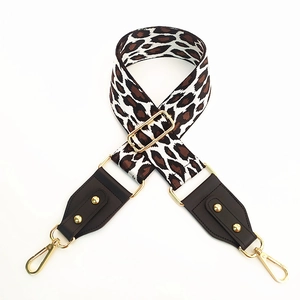 Adjustable leopard print bag strap with brown leather ends and gold metal hardware