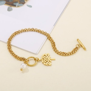 Detail of gold layered tree of life bracelet with white pearl and OT toggle clasp
