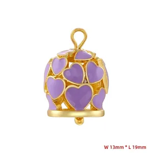 Detail view of gold bell pendant with purple hearts and 13mm by 19mm size dimensions