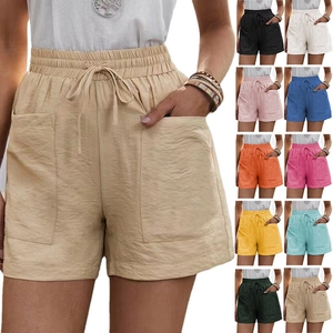 Detail of high waisted drawstring linen shorts showing a variety of available colors