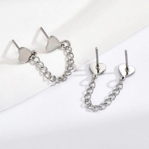 Detailed close-up of heart chain earrings in polished silver stainless steel