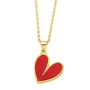 Minimalist gold chain necklace featuring a red enamel heart pendant with beaded edge