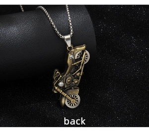 Macro view of the back of a vintage bronze motorcycle pendant with rhinestone accents