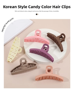 Close-up of assorted matte candy-colored large hair clips on minimalist display stands