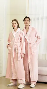 Close-up of pink coral fleece robe with white contrast collar and soft belted waist