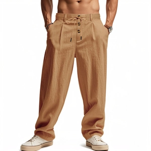 Detail view of khaki linen drawstring trousers featuring elastic waist and button accents