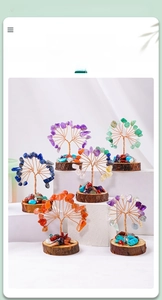 Detail of handmade crystal tree with natural wood base and copper wire branches