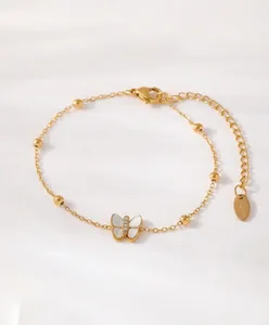 Detailed macro of 18k gold plated butterfly bracelet with mother of pearl and zircon