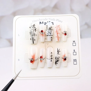 Detail of handmade press-on nails with ink bamboo art, calligraphy, and delicate rhinestones