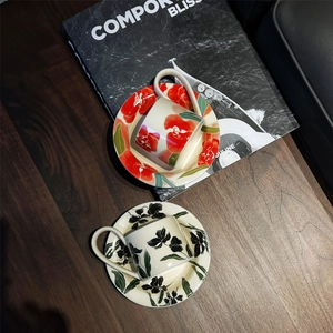 Retro ceramic iris coffee cup and saucer sets in red and black on wooden table