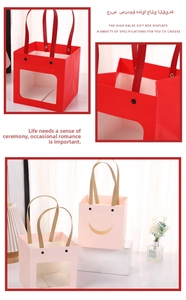Close-up of kraft paper gift bags with transparent windows and reinforced ribbon handles