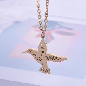 Detailed close-up of 18K gold-plated hummingbird pendant with elegant cutout lines on chain