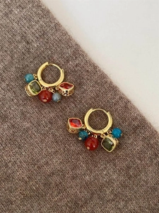 Detailed close-up of ethnic style beaded hoop earrings with zircon and agate charms