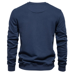 Rear view of navy blue crewneck sweatshirt with ribbed cuffs and thick fleece texture
