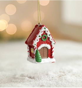 Detail of resin Christmas cottage ornament with festive glitter and snow background