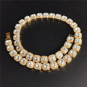 Men's hip hop gold necklace with large square white gemstones and crystals on black background
