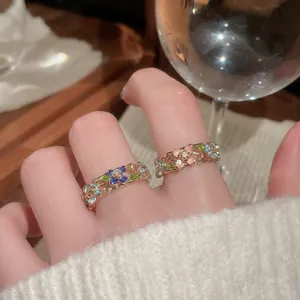Elegant gold plated open rings with floral enamel petals and diamonds on hand