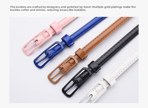 Close-up of thin candy-colored waist belts with polished metal buckles in multiple colors