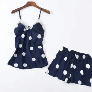 Women's dark blue polka dot satin pajama set with white lace trim top and shorts