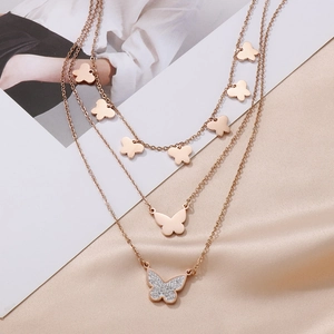Detail of rose gold multi-layer butterfly pendant necklace with sparkling crystals