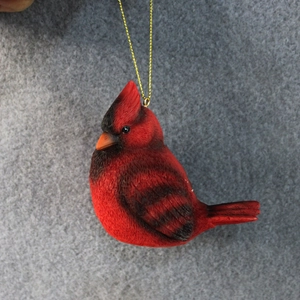 Red cardinal bird ornament with golden hanging string for festive Christmas decoration