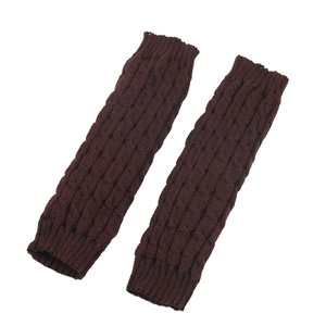 Detailed view of dark brown cable-knit leg warmers with diamond pattern and ribbed cuffs