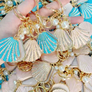 Detail of shell keychain with blue pink enamel and crystals with white pearls