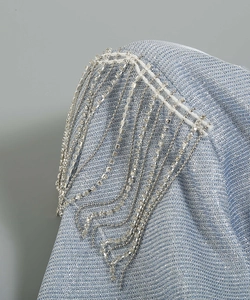 Detail of light blue metallic fabric with silver chains and sparkling rhinestones