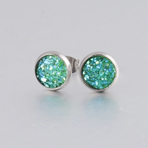 Macro view of 8mm silver stainless steel earrings with green glitter crystal inlay