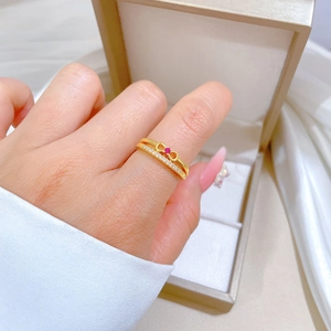 Double-layered gold bow ring with red gemstone and micro-pave crystals for women
