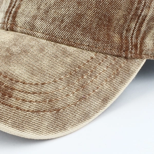 Detail shot of heavy denim stitching and retro twill texture on a stylish baseball cap