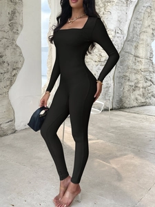 Close-up of black long sleeve ribbed yoga jumpsuit showing texture and slim fit