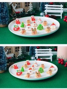 Macro detail of various cute resin Christmas charms like gingerbread men and trees on a plate